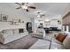 Inviting living room with stylish furnishings, shelving decor, and view into the kitchen at 4473 E Whitehall Dr, San Tan Valley, AZ 85140