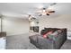 This living room features a gray sectional, stairs, carpet flooring, and beige walls at 4473 E Whitehall Dr, San Tan Valley, AZ 85140