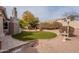 Serene backyard featuring a manicured lawn, fountain, and decorative landscaping, creating a peaceful outdoor retreat at 4552 E Chuckwalla Cyn, Phoenix, AZ 85044