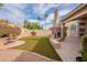 Landscaped backyard featuring a stone fireplace, fountain, and ample space for outdoor entertaining and relaxation at 4552 E Chuckwalla Cyn, Phoenix, AZ 85044