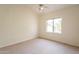 Bright bedroom features neutral walls, carpet flooring, a ceiling fan, and a window at 4552 E Chuckwalla Cyn, Phoenix, AZ 85044