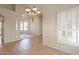 Open dining area with tile floors, decorative pillars, neutral walls, and chandelier lighting at 4552 E Chuckwalla Cyn, Phoenix, AZ 85044