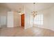 Bright dining area featuring tiled floors, white walls, shutters, and elegant chandelier lighting at 4552 E Chuckwalla Cyn, Phoenix, AZ 85044