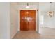 Inviting entryway featuring a solid wood double door, tile flooring, and stylish light fixtures at 4552 E Chuckwalla Cyn, Phoenix, AZ 85044