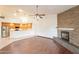 Spacious living room with a stone fireplace and a ceiling fan at 4552 E Chuckwalla Cyn, Phoenix, AZ 85044