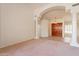 Open living area featuring an archway entrance, decorative pillars, and tile flooring at 4552 E Chuckwalla Cyn, Phoenix, AZ 85044