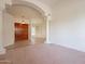 Open living area featuring an archway entrance, decorative pillars, and tile flooring at 4552 E Chuckwalla Cyn, Phoenix, AZ 85044