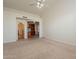 Bright living room with neutral carpet, ceiling fan, and ample natural light from adjacent spaces at 4552 E Chuckwalla Cyn, Phoenix, AZ 85044