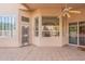 Outdoor covered patio featuring tiled flooring, large windows, and backyard access at 4552 E Chuckwalla Cyn, Phoenix, AZ 85044