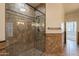 Tiled shower featuring seamless glass door and bronze fixtures at 4552 E Chuckwalla Cyn, Phoenix, AZ 85044