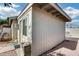 View of the backyard stand-alone dwelling, featuring vinyl siding and a window AC unit at 4725 E Brown Rd # 59, Mesa, AZ 85205