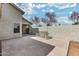 Wide backyard view with concrete patio and a light-colored block perimeter wall at 4725 E Brown Rd # 59, Mesa, AZ 85205