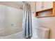 Bathroom showcasing a shower-tub combo, with a white tiled surround at 4725 E Brown Rd # 59, Mesa, AZ 85205