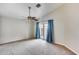 Cozy bedroom with plush carpeting, a ceiling fan, and a sliding glass door to the outside patio at 4725 E Brown Rd # 59, Mesa, AZ 85205