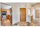 Entryway featuring a wooden door, unique tile flooring, and views into the kitchen at 4725 E Brown Rd # 59, Mesa, AZ 85205