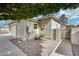 Charming home exterior featuring desert landscaping, side yard access, and neutral stucco in a quiet neighborhood at 4725 E Brown Rd # 59, Mesa, AZ 85205