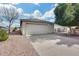 Home exterior showcasing a two-car garage, desert landscaping, and a serene residential street with clear blue skies at 4725 E Brown Rd # 59, Mesa, AZ 85205