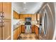 Kitchen featuring stainless steel appliances, tile backsplash, wood cabinets and slate floors at 4725 E Brown Rd # 59, Mesa, AZ 85205