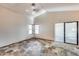 Living room boasting a vaulted ceiling, slate floors, ceiling fan, and sliding glass doors at 4725 E Brown Rd # 59, Mesa, AZ 85205