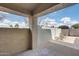 A cozy patio with concrete flooring, cinder block walls, and partial views of neighborhood landscaping in the distance at 4725 E Brown Rd # 59, Mesa, AZ 85205