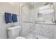 A modern shower with a glass door, stylish marble tile, grab bars, and a tiled floor at 4725 E Brown Rd # 59, Mesa, AZ 85205