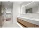 Bright bathroom featuring a double vanity, a large mirror, and a glass shower with neutral tile at 5000 N Camelback Ridge Rd # 210, Scottsdale, AZ 85251