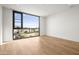 Bright bedroom featuring hardwood floors and a large window with neighborhood views at 5000 N Camelback Ridge Rd # 210, Scottsdale, AZ 85251