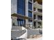 Contemporary building entrance featuring stone accents, wood soffits and desert landscaping at 5000 N Camelback Ridge Rd # 210, Scottsdale, AZ 85251