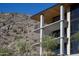 Close up of a modern building with balconies and desert landscaping at the base of a mountain at 5000 N Camelback Ridge Rd # 210, Scottsdale, AZ 85251