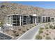 Beautiful modern condo building with balconies and desert landscaping at the base of a mountain at 5000 N Camelback Ridge Rd # 210, Scottsdale, AZ 85251