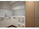 Close up of a modern kitchen featuring white cabinets, stainless steel appliances, and light wood accents at 5000 N Camelback Ridge Rd # 210, Scottsdale, AZ 85251