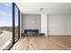 Contemporary living room featuring a modern fireplace, large windows with scenic views, and hardwood floors at 5000 N Camelback Ridge Rd # 210, Scottsdale, AZ 85251