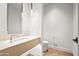 Modern powder room featuring a floating vanity with stone countertop and pendant lighting at 5000 N Camelback Ridge Rd # 210, Scottsdale, AZ 85251