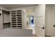 Bright walk-in closet boasts ample shelving, drawers, and an island, connecting seamlessly to the luxurious bathroom at 5000 N Camelback Ridge Rd # 210, Scottsdale, AZ 85251