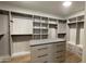 Custom walk-in closet featuring shelving, drawers, and wooden floors, providing organized storage solutions at 5000 N Camelback Ridge Rd # 210, Scottsdale, AZ 85251