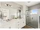 Bathroom featuring double sinks, mirrors, tiled floors, and walk-in shower at 5100 E Rancho Paloma Dr # 2024, Cave Creek, AZ 85331