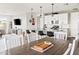 Bright kitchen and dining room area featuring white cabinets, granite countertops, stainless steel appliances and wood flooring at 5100 E Rancho Paloma Dr # 2024, Cave Creek, AZ 85331