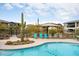 Community pool area featuring a cactus, desert landscaping, and lounge chairs at 5100 E Rancho Paloma Dr # 2024, Cave Creek, AZ 85331