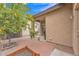 Picturesque backyard featuring a lemon tree, brick pavers, covered patio, and lush landscaping at 5206 W Desert Hills Dr, Glendale, AZ 85304