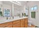 Well-lit bathroom with a double sink vanity, tiled floors, a large mirror, and a walk-in shower with sliding glass doors at 5206 W Desert Hills Dr, Glendale, AZ 85304