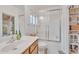 Well-lit bathroom with a single sink vanity, tiled floors, a large mirror, and a shower and tub combo with sliding glass doors at 5206 W Desert Hills Dr, Glendale, AZ 85304