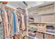 Organized walk-in closet with ample shelving, hanging rods, and storage baskets for optimal storage solutions at 5206 W Desert Hills Dr, Glendale, AZ 85304