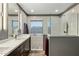 Modern bathroom featuring dual sinks, a walk-in shower with glass surround, and stylish fixtures at 5210 E Danbury Rd, Scottsdale, AZ 85254