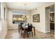 Bright dining room showcasing pool views through a large window and modern decor at 5210 E Danbury Rd, Scottsdale, AZ 85254