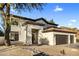 Charming home featuring a well-maintained exterior with desert landscaping and a three-car garage at 5210 E Danbury Rd, Scottsdale, AZ 85254