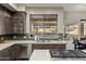 Kitchen with granite countertops, stainless steel dishwasher and view of the pool at 5210 E Danbury Rd, Scottsdale, AZ 85254