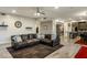 Cozy living room with a comfortable leather sectional, providing an inviting space for relaxation and entertainment at 5210 E Danbury Rd, Scottsdale, AZ 85254