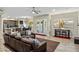 Spacious living room featuring a modern ceiling fan, hardwood floors, and access to the outdoor pool area at 5210 E Danbury Rd, Scottsdale, AZ 85254