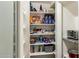 Walk-in pantry offers generous storage space with organized shelves for food and essentials at 5210 E Danbury Rd, Scottsdale, AZ 85254