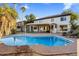 Sparkling pool features a brick surround and is adjacent to the covered patio in the expansive backyard at 5210 E Danbury Rd, Scottsdale, AZ 85254